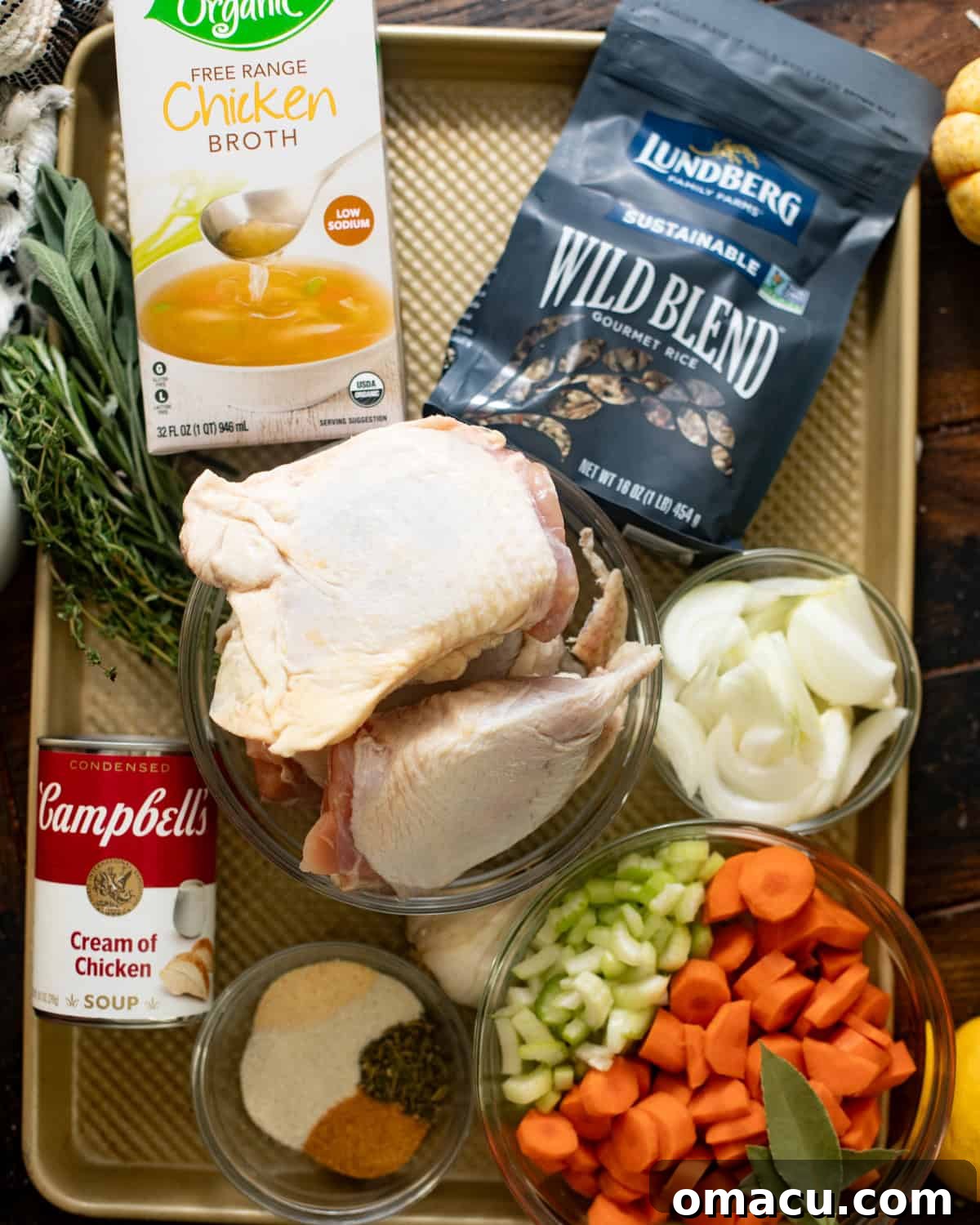 ingredients to make chicken wild rice soup on a baking tray.