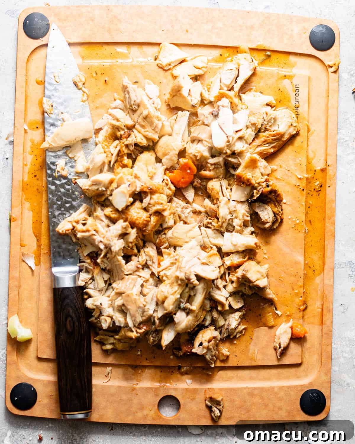 shredded chicken in a cutting board. 
