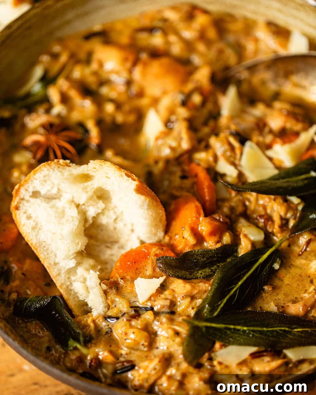 creamy chicken and wild rice soup in a bowl with crusty bread.
