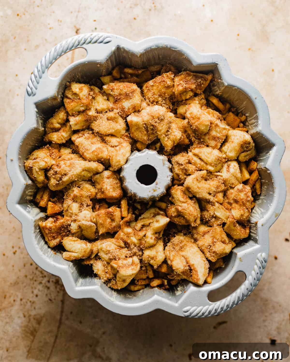 apple cider monkey bread assembled in a bundt pan. 