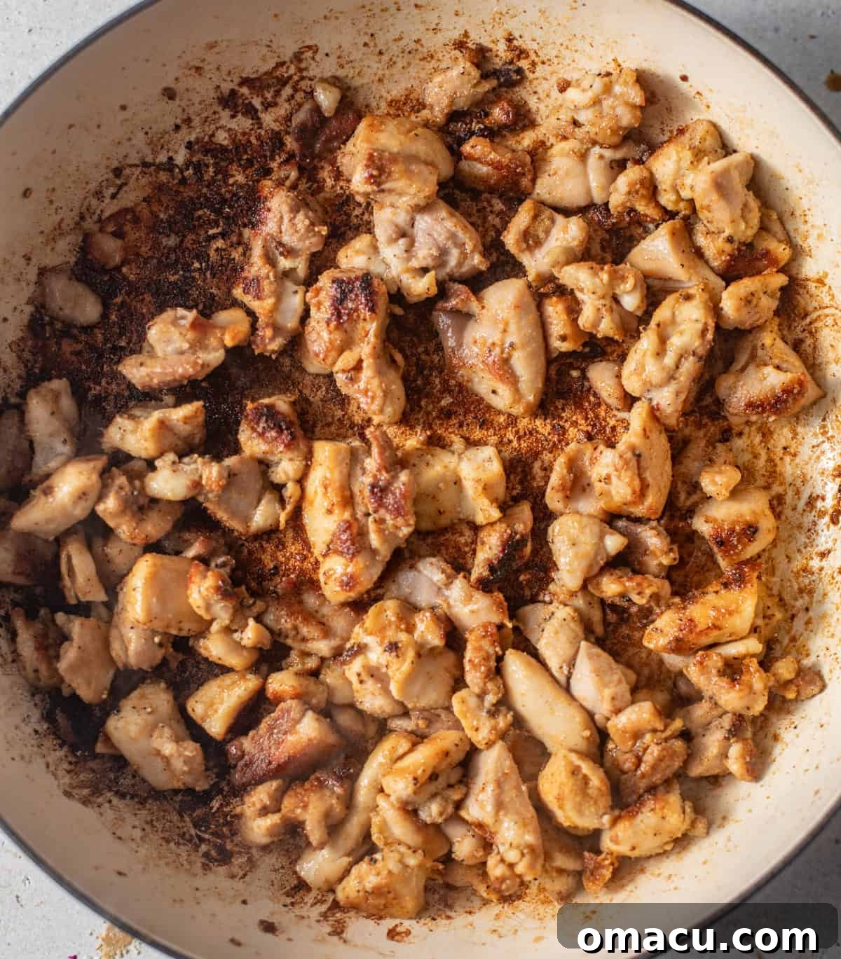 seared chicken and bacon in a pot.