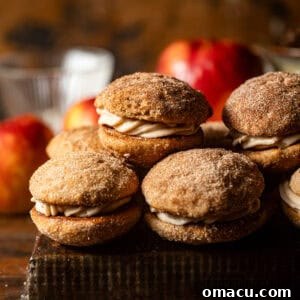 apple cider whoopie pies stacked on top of each other on a serving tray.