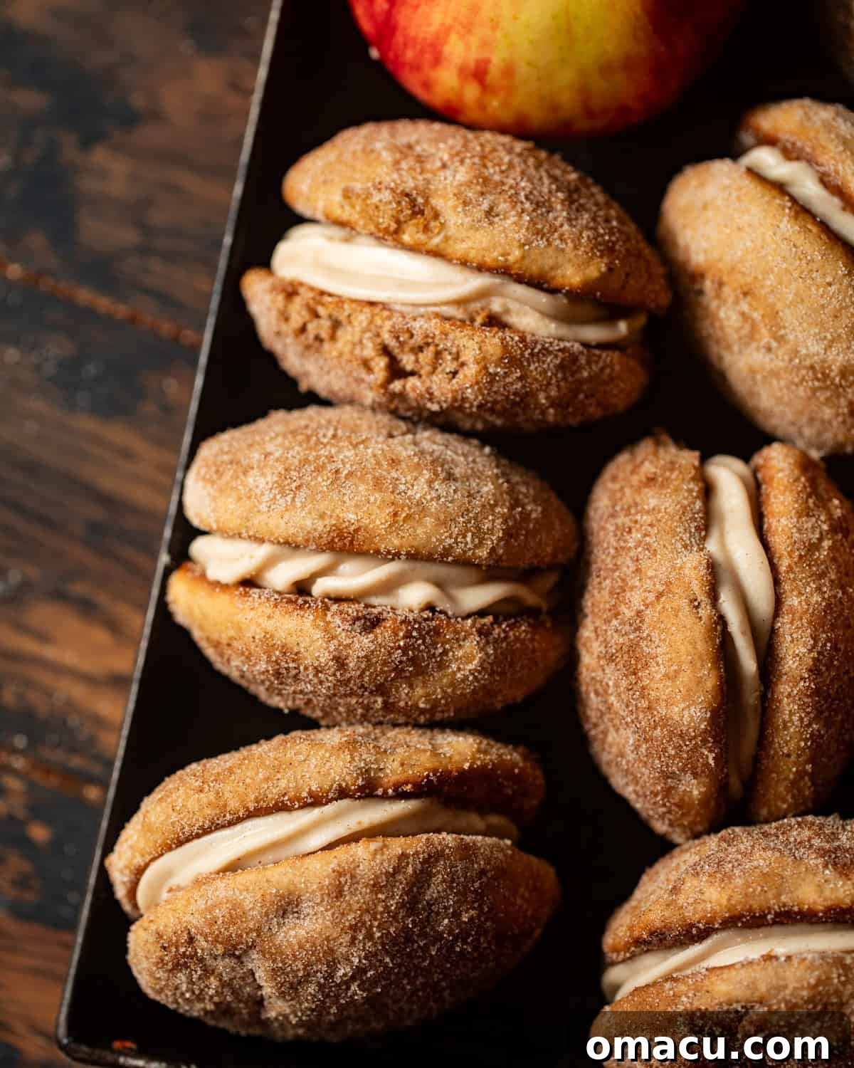 apple cider whoopie pies laid together in a tray.
