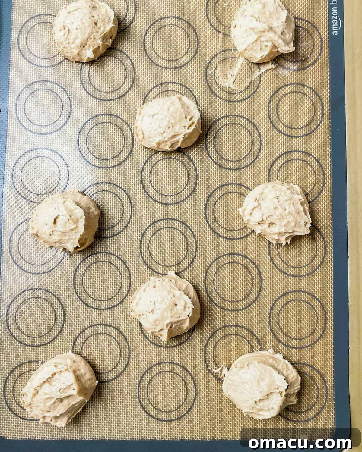 whoopie pie dough scooped onto a baking sheet.