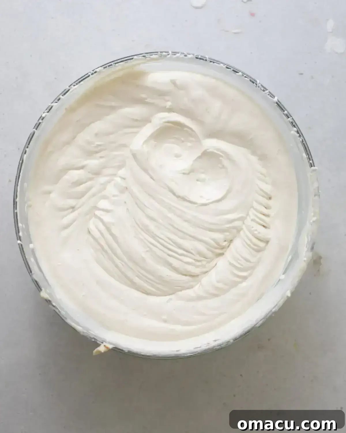 cinnamon cream cheese frosting whipped together in a bowl. 