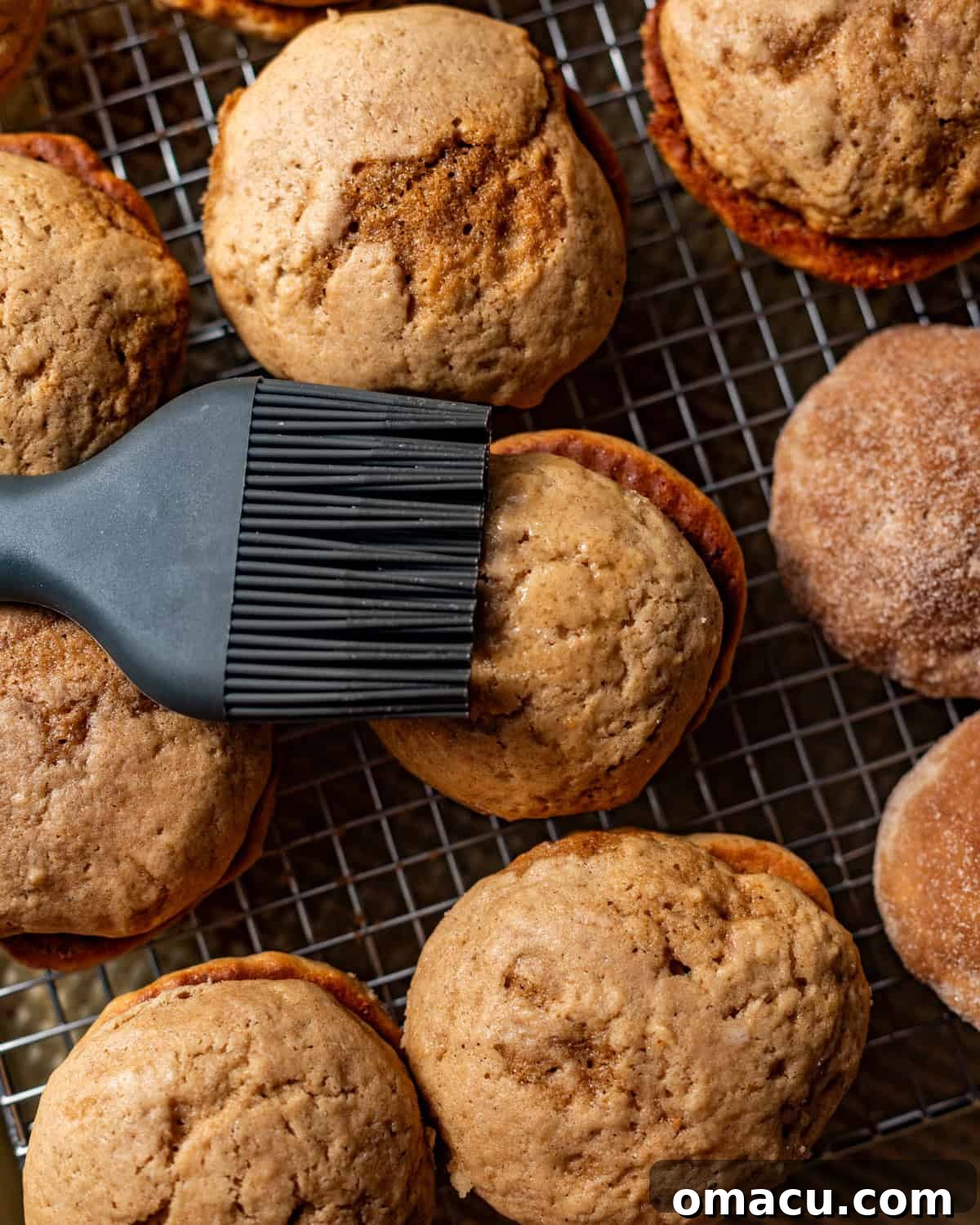 melted butter being brushed on top of the whoopie pies.