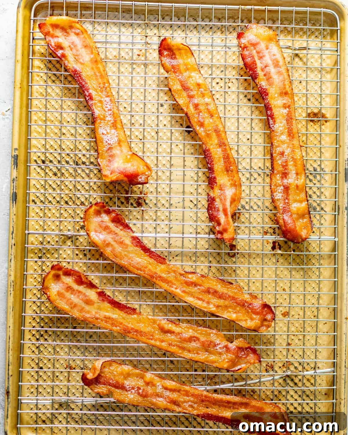Crispy cooked bacon strips cooling on a wire rack, ready to be crumbled for the twice baked mashed potatoes.