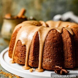 brown sugar pound cake on a cake plate with toffee bourbon glaze on top.