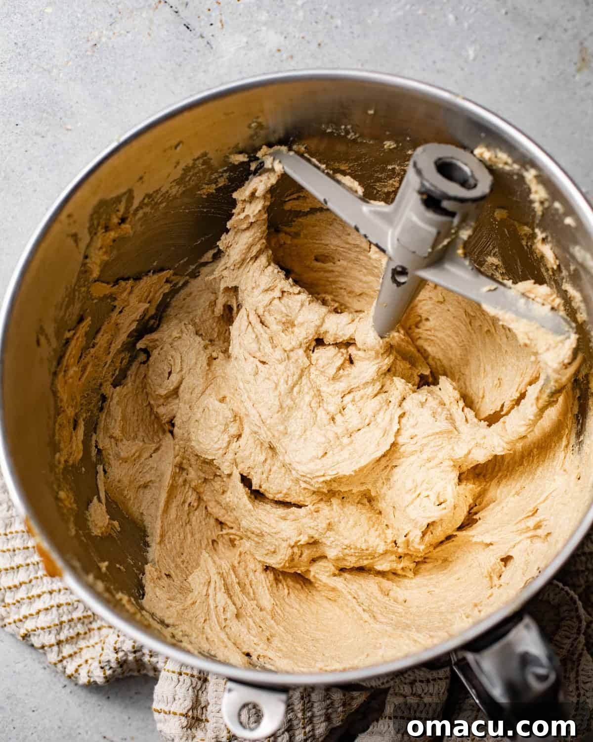Butter, shortening, brown sugar, molasses, and oil being creamed together in a stand mixer bowl until light and fluffy.