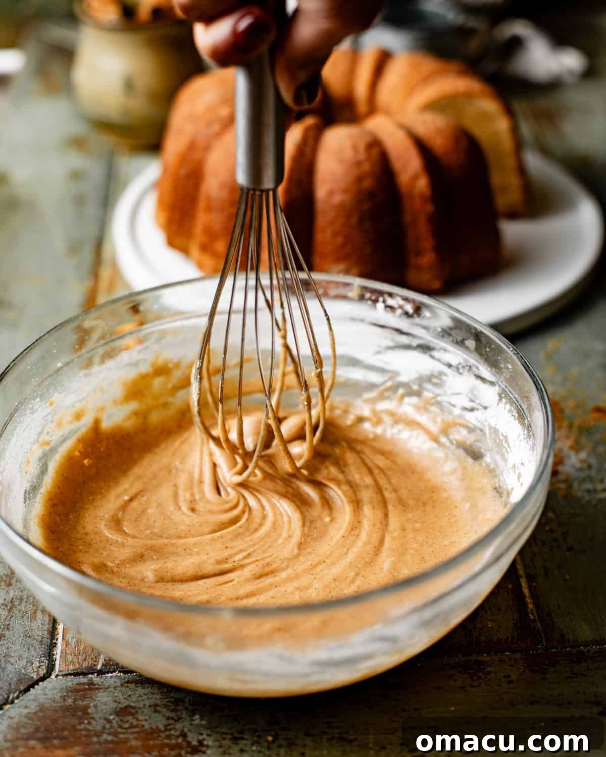 A rich, glossy toffee bourbon glaze perfectly mixed in a small bowl, ready to be poured.