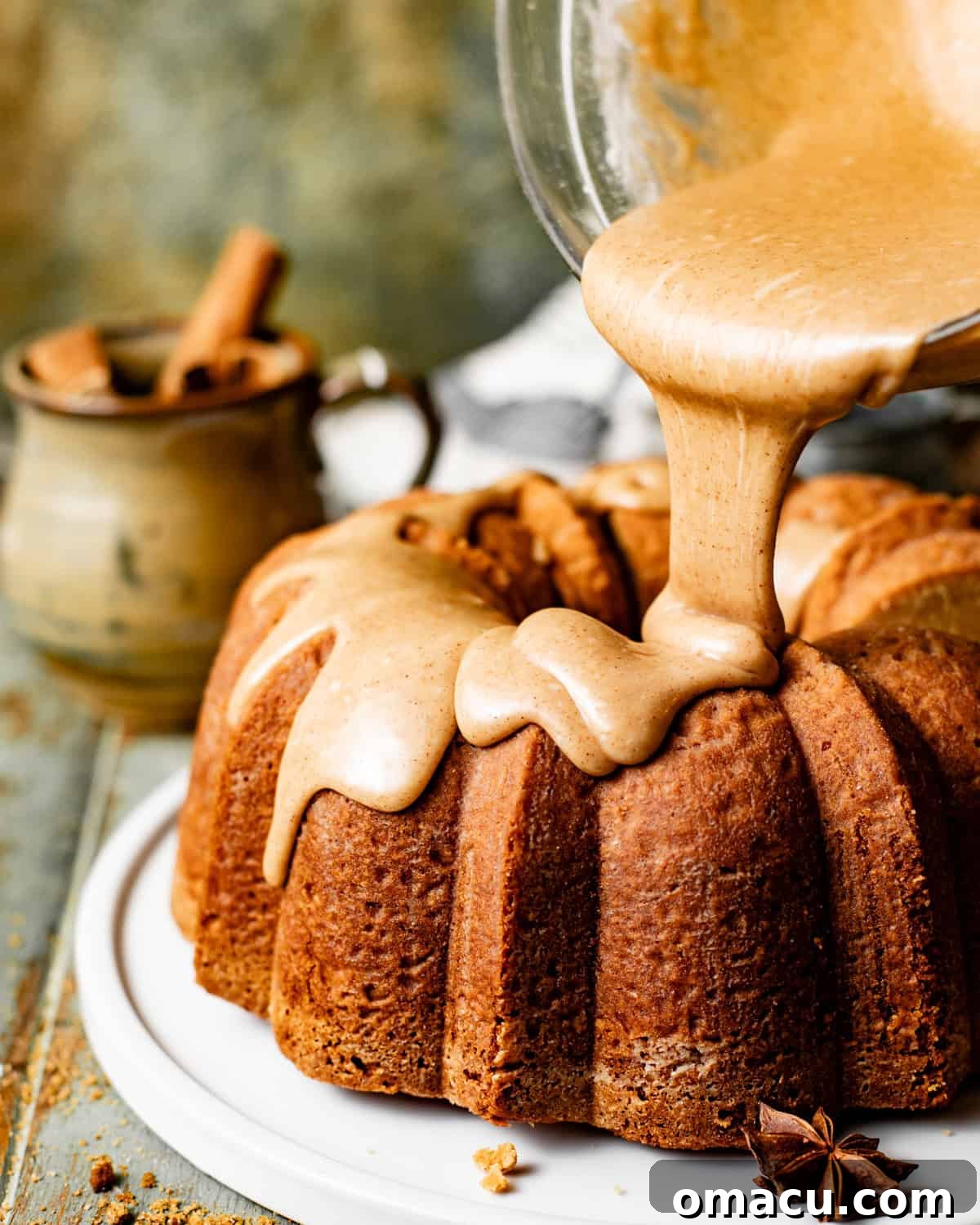 The decadent toffee bourbon glaze being artfully poured over the cooled brown sugar pound cake, creating beautiful drips.