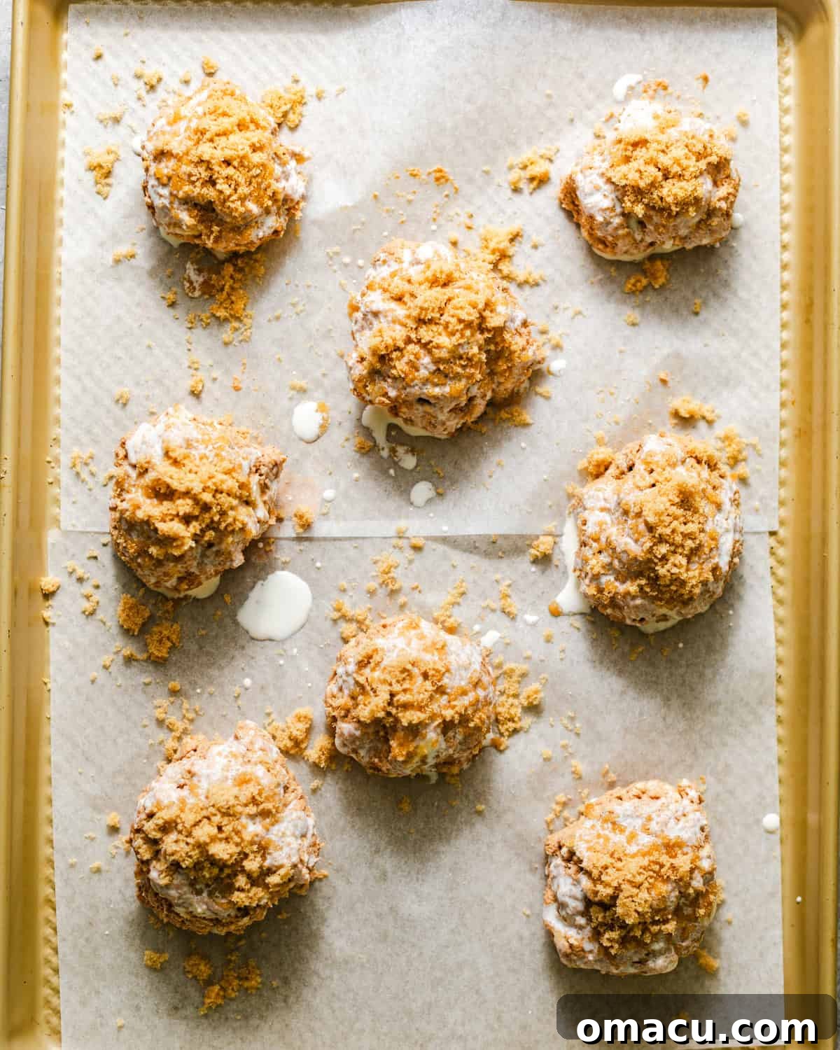 Sweet potato biscuits arranged on a parchment-lined baking sheet, prepared for baking.