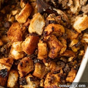 golden brown sage and sausage stuffing in a baking dish, ready to be served.