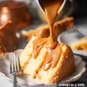 A tantalizing slice of Southern Caramel Cake on a plate, gleaming with its rich, glossy caramel topping.