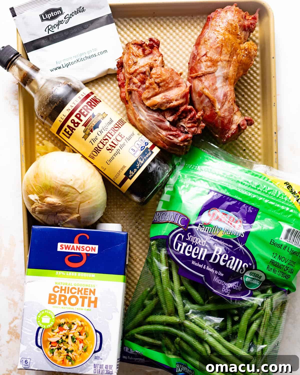 ingredients to make slow cooker collard greens - fresh green beans, smoked turkey legs, chicken broth, butter, worcestershire sauce, lipton soup mix, onion, garlic, and seasonings.