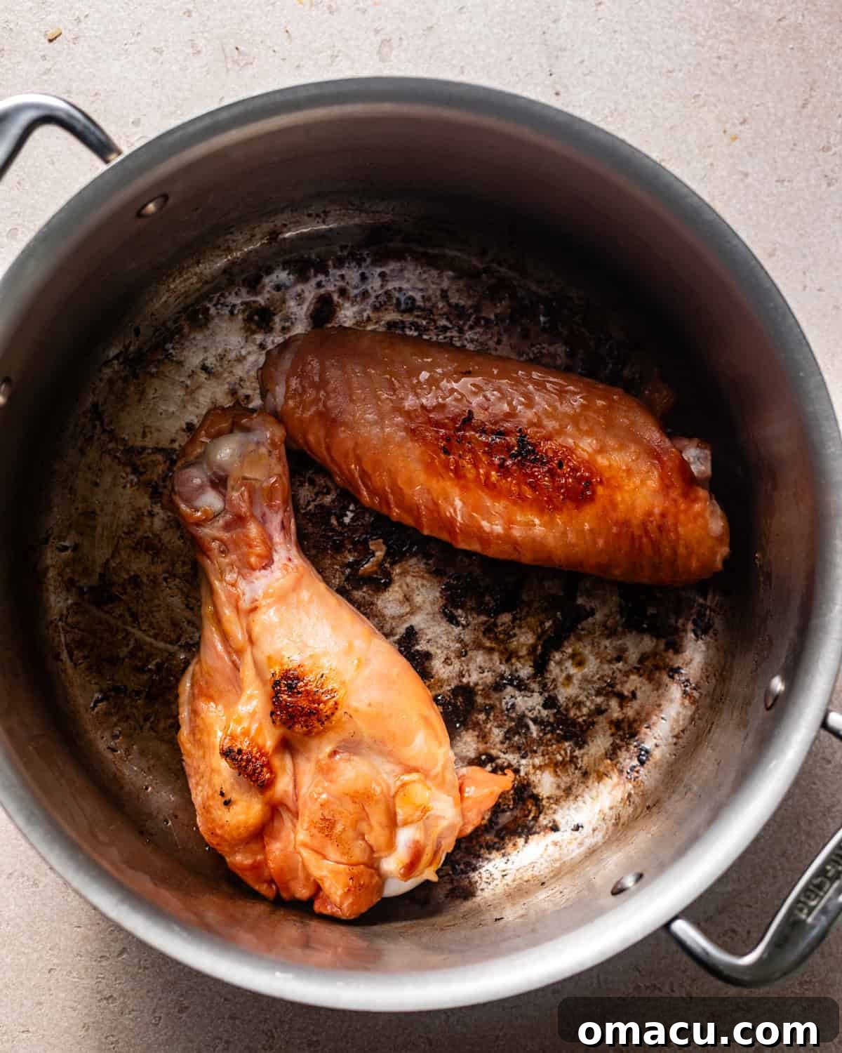 seared turkey legs in a skillet.