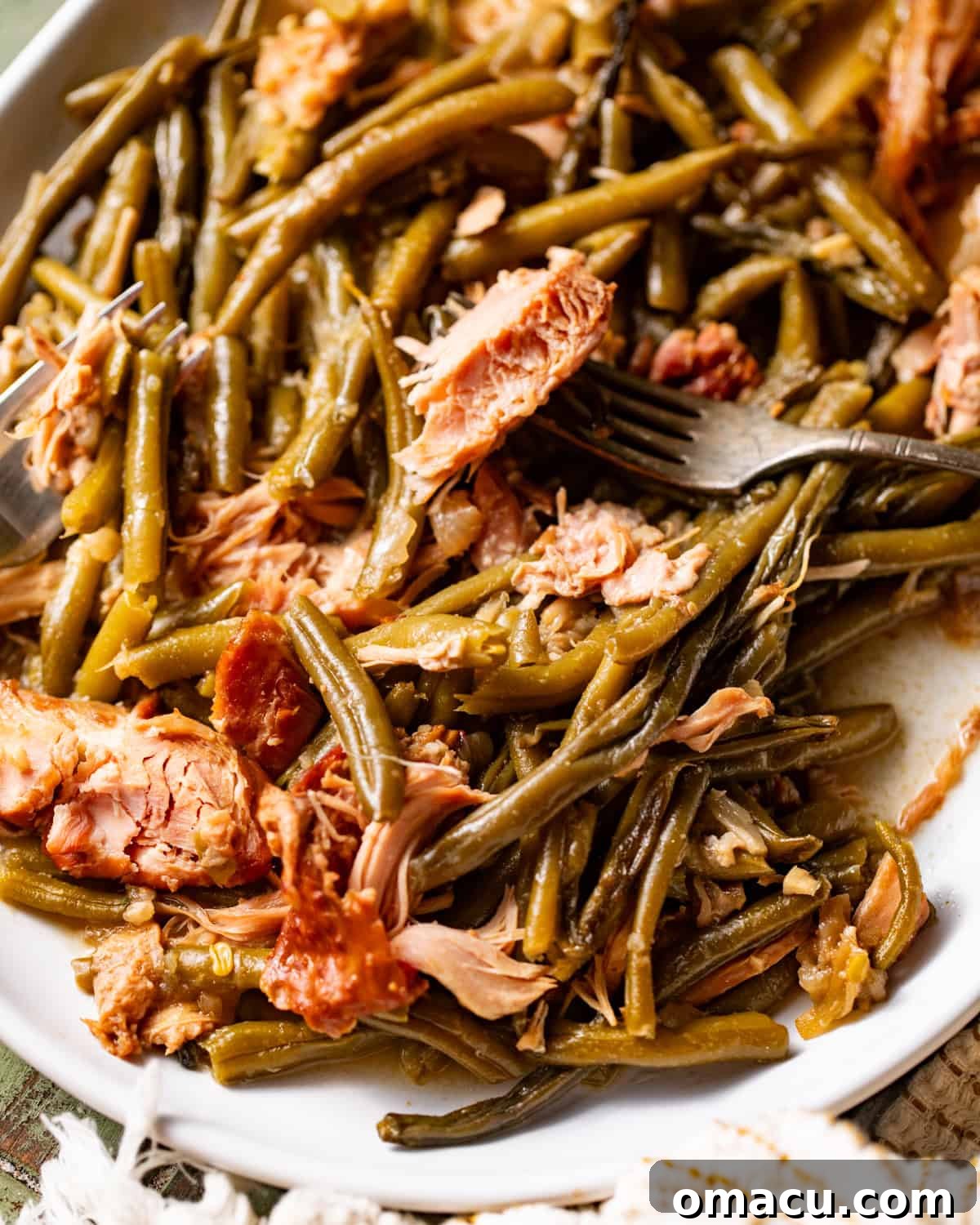 slow cooker green beans on a white serving plate.