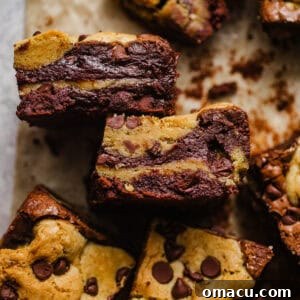 Fudgy brookies on a piece of parchment paper cut into squares.