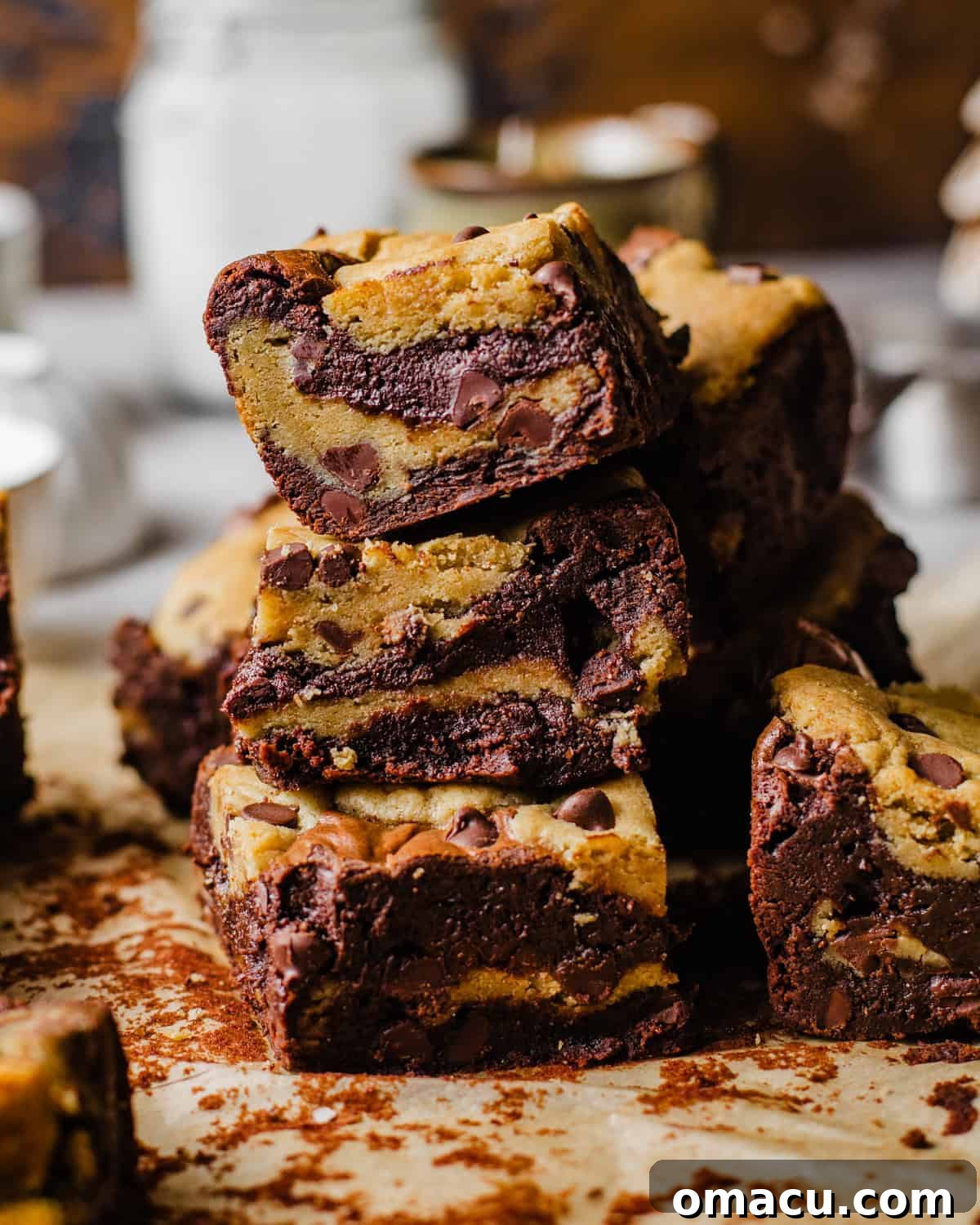 Fudgy brookies sliced into perfect squares and neatly stacked, showing their decadent layers.