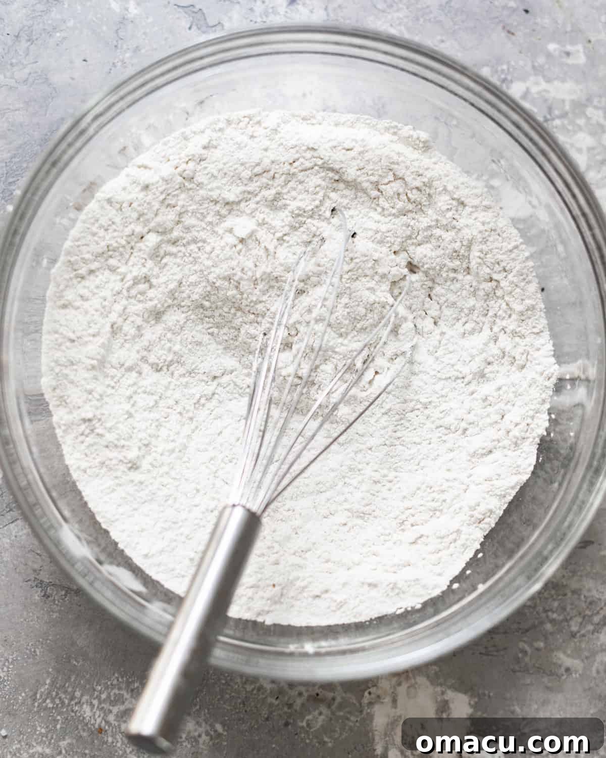 Dry ingredients (flour, spices, leavening) whisked together in a mixing bowl.