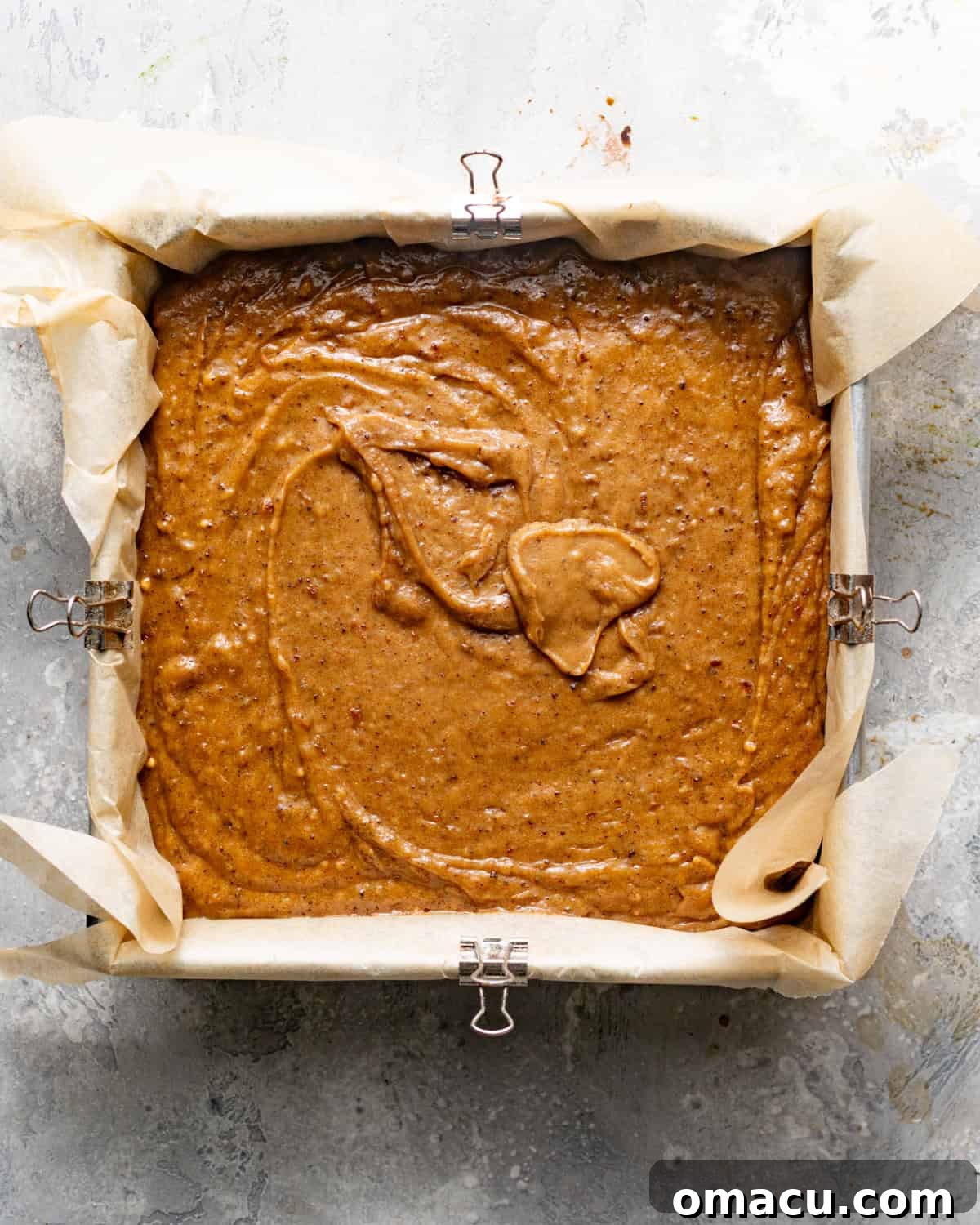Cake batter in a square baking dish.