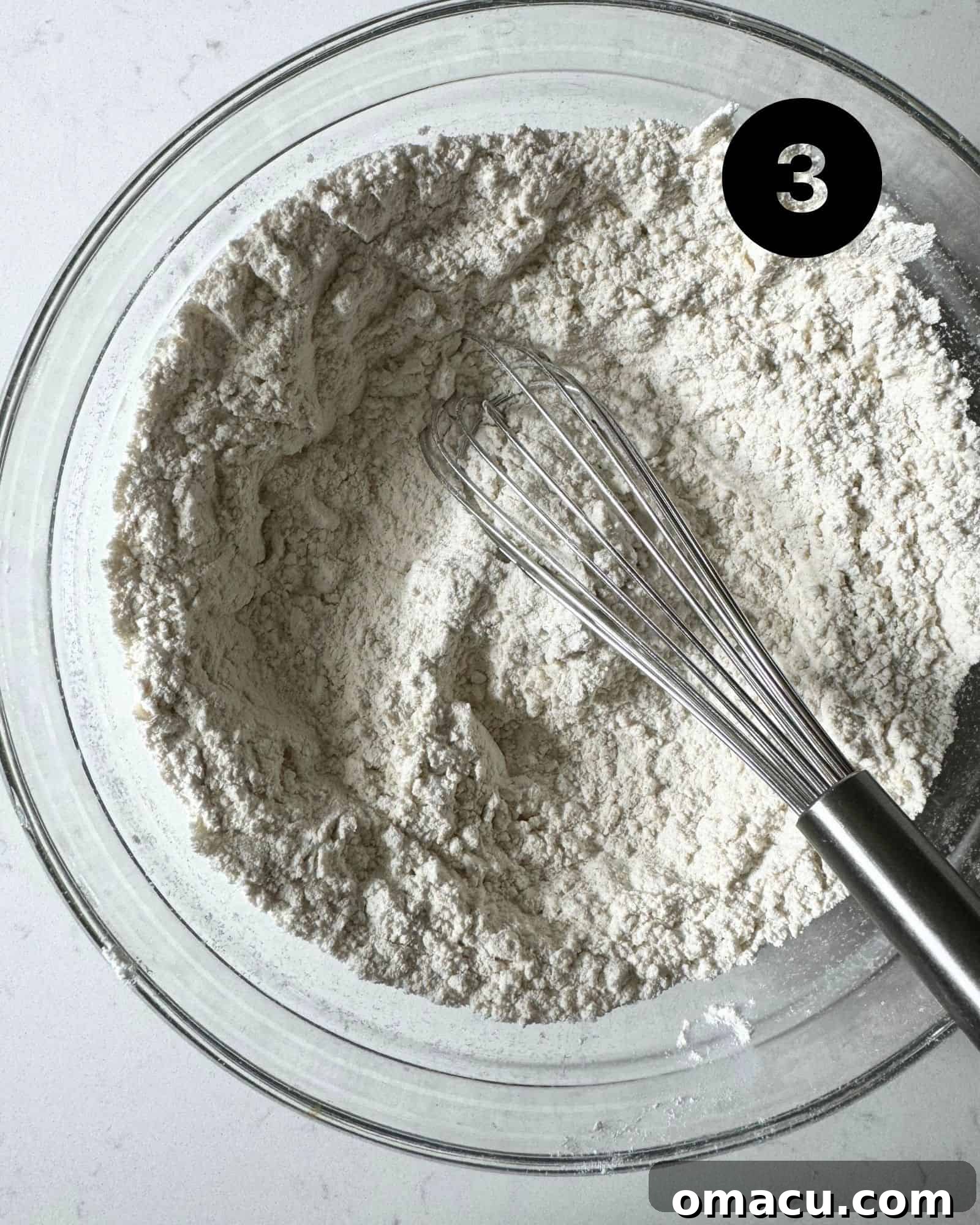 Dry ingredients including flour, baking soda, kosher salt, and nutmeg, whisked together in a large mixing bowl.