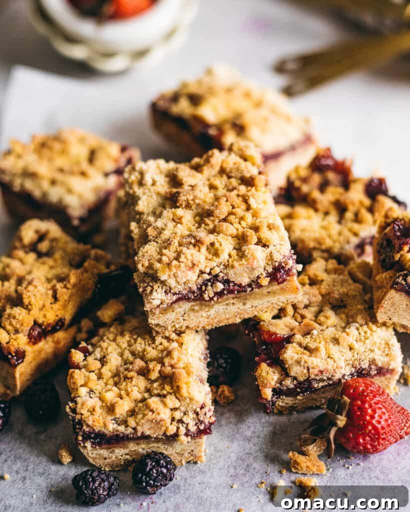 Close-up of Brown Butter Mixed Berry Crumble Bars with the golden-brown crust visible.