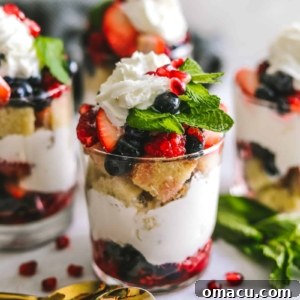 Mixed Berry Trifles in a cup with berries and spoons