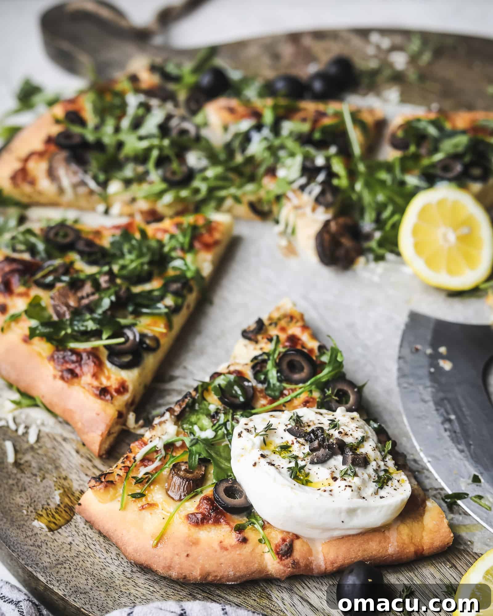 Close-up of freshly baked Black Olive Pizza with melted cheese, mushrooms, and olives