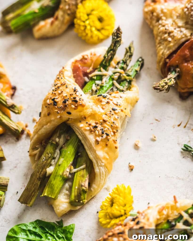 Close-up of baked Asparagus and Prosciutto Puff Pastry Bundles arranged neatly