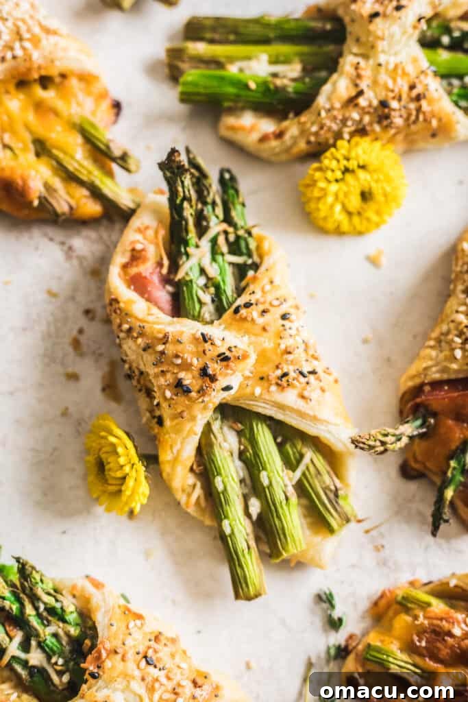 A tray of uncooked Asparagus and Prosciutto Puff Pastry Bundles before baking