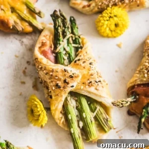 Asparagus and Prosciutto Puff Pastry Bundles on a piece of parchment paper