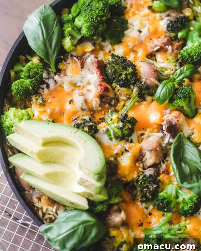 Ingredients laid out for the Easy Chicken Broccoli Rice and Cheese Casserole, including fresh herbs, chicken, and cheeses.