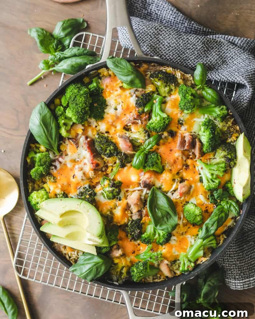 A generous serving of Easy Chicken Broccoli Rice and Cheese Casserole, scooped into a bowl, showcasing its creamy texture and rich ingredients.