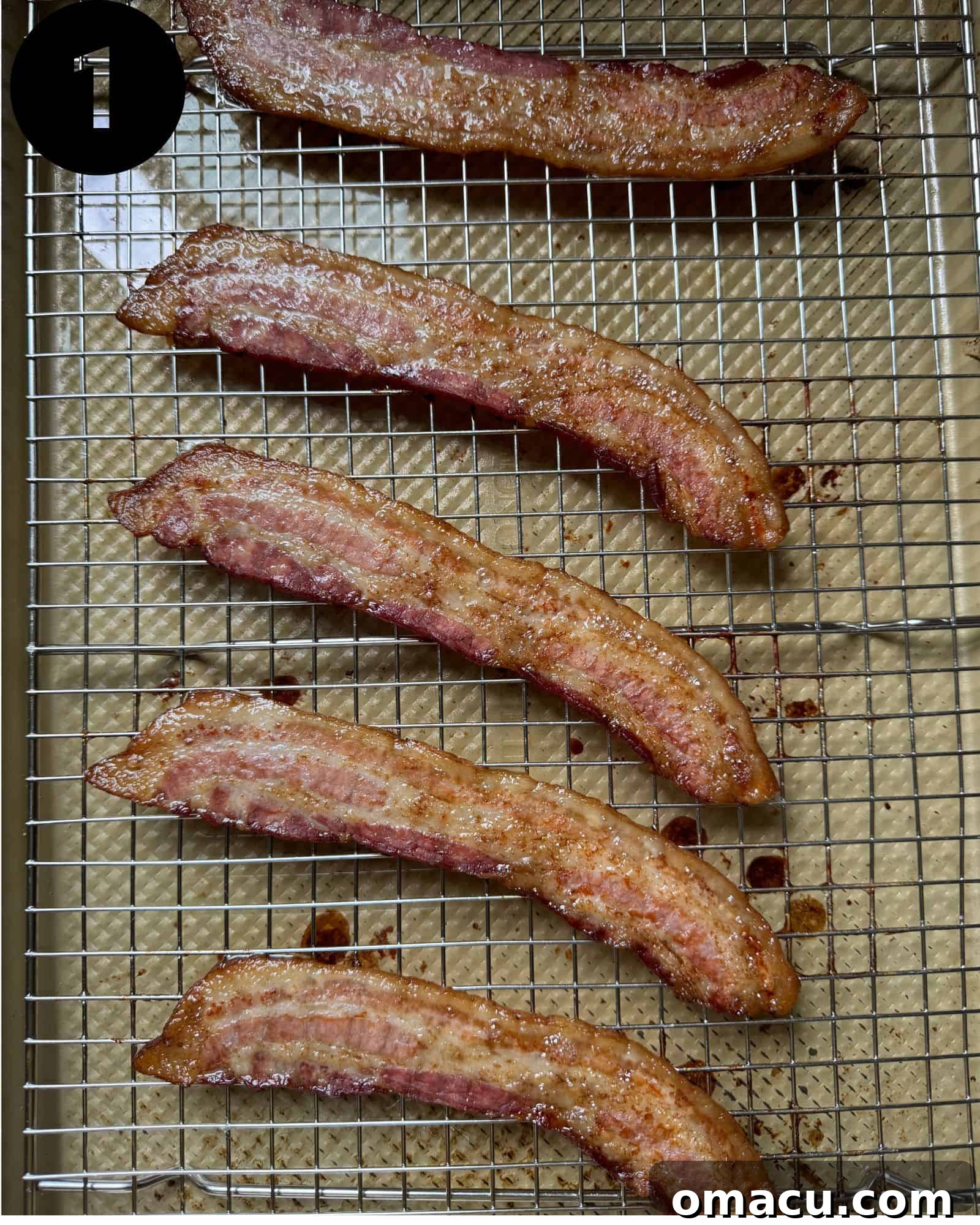 Crispy cooked bacon strips arranged neatly on a wire rack, allowing excess grease to drain, showcasing its golden-brown perfection.