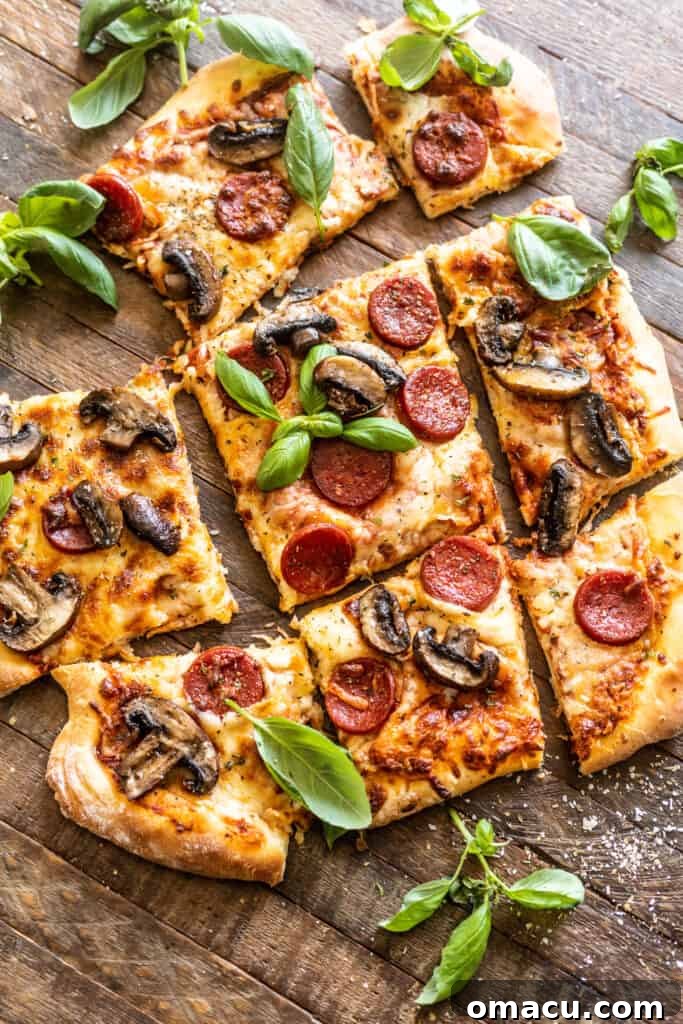 Delicious homemade roasted mushroom and pepperoni pizza on a rustic wooden table, ready to be sliced.