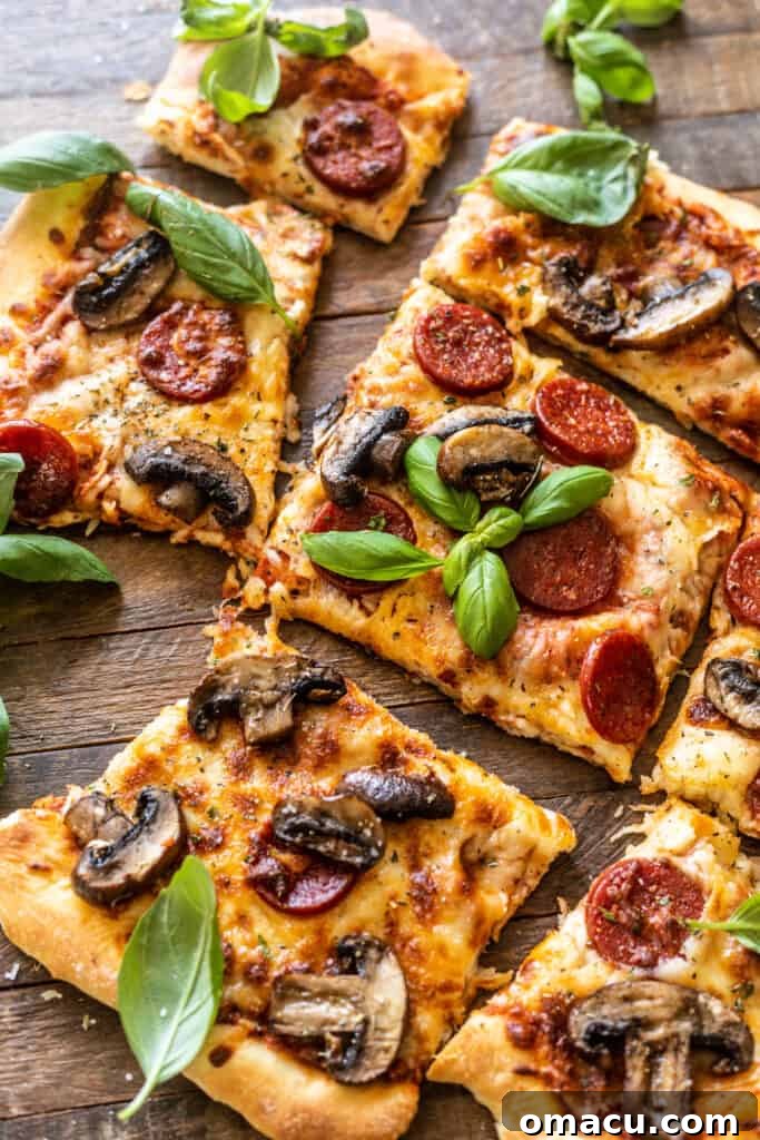 Close-up shot of the roasted mushroom and pepperoni pizza, showcasing the crispy crust and melted cheese.