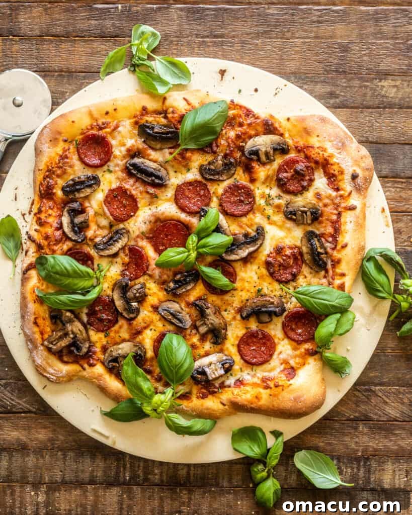 A large, perfectly baked homemade pepperoni pizza on a dark surface.