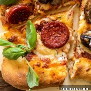 a slice of pepperoni pizza on a pizza stone with basil