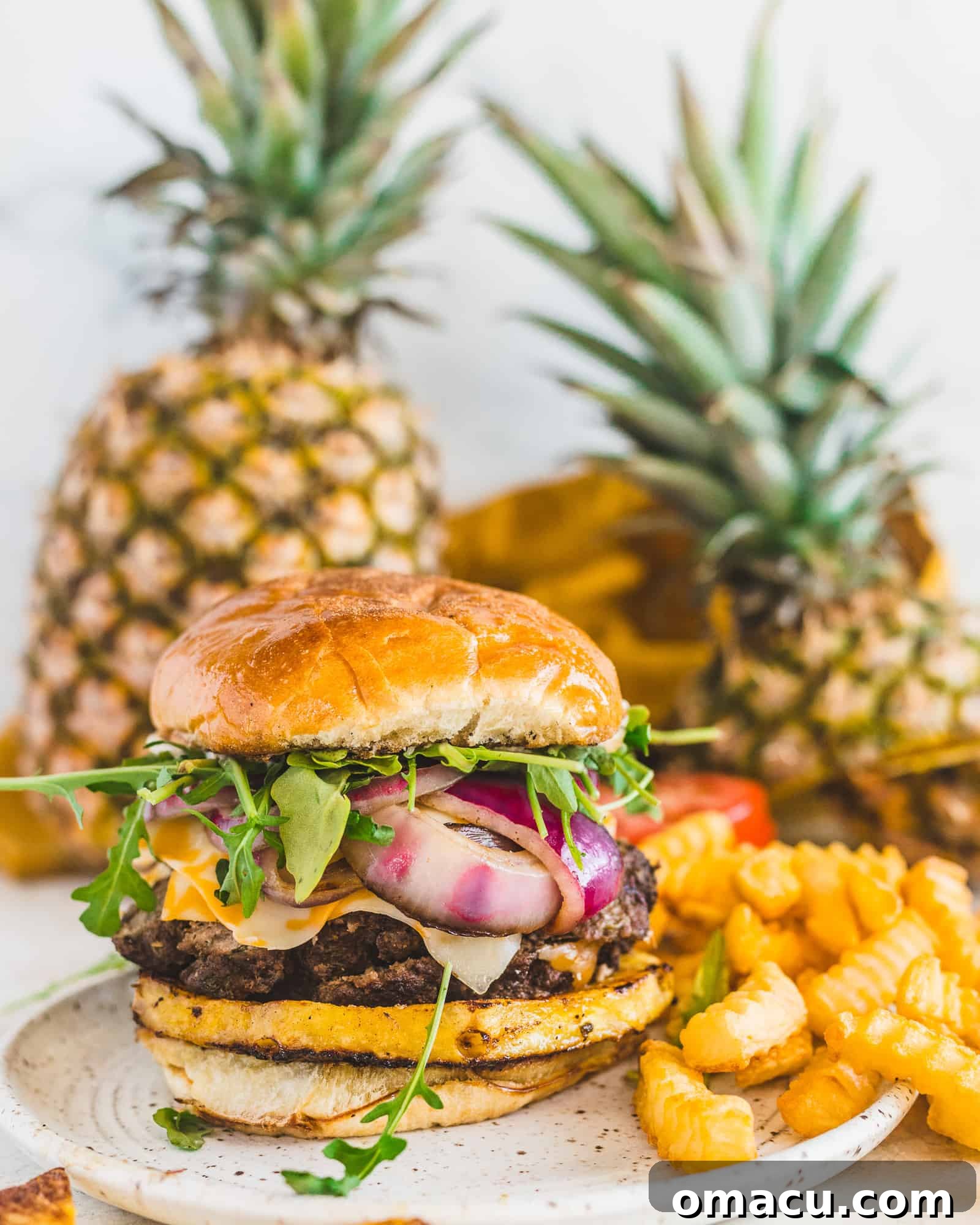 A top-down view of the Jamaican Jerk Burger, showcasing its layers of deliciousness, including the vibrant toppings and the toasted brioche bun.