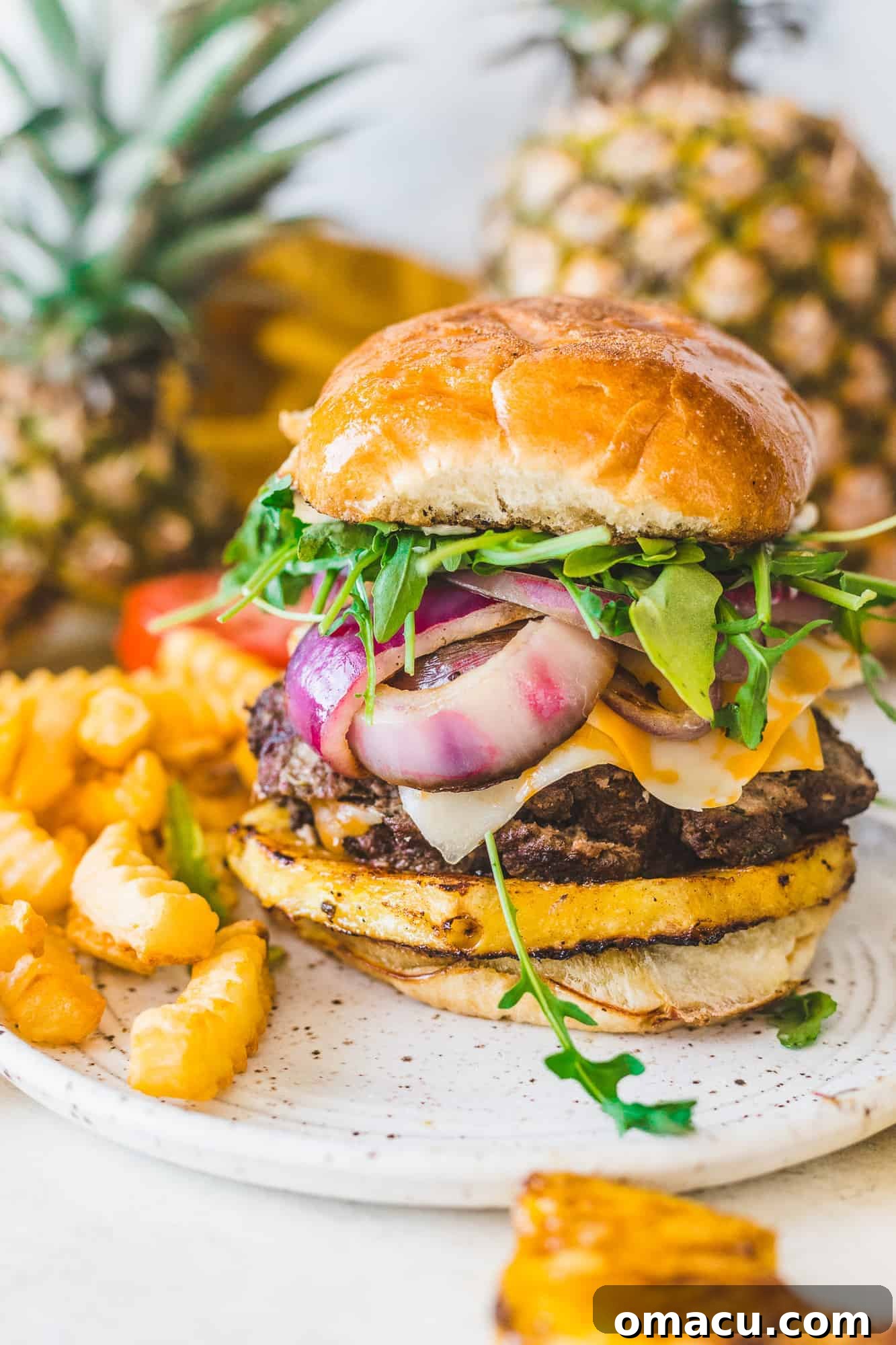 A close-up of a hand holding a Jamaican Jerk Burger, inviting diners to savor its unique blend of flavors.