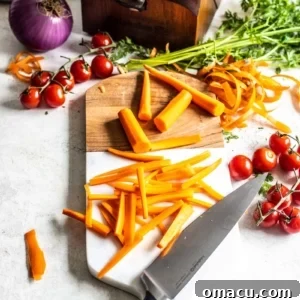 Julienne carrots on cutting board with a knife