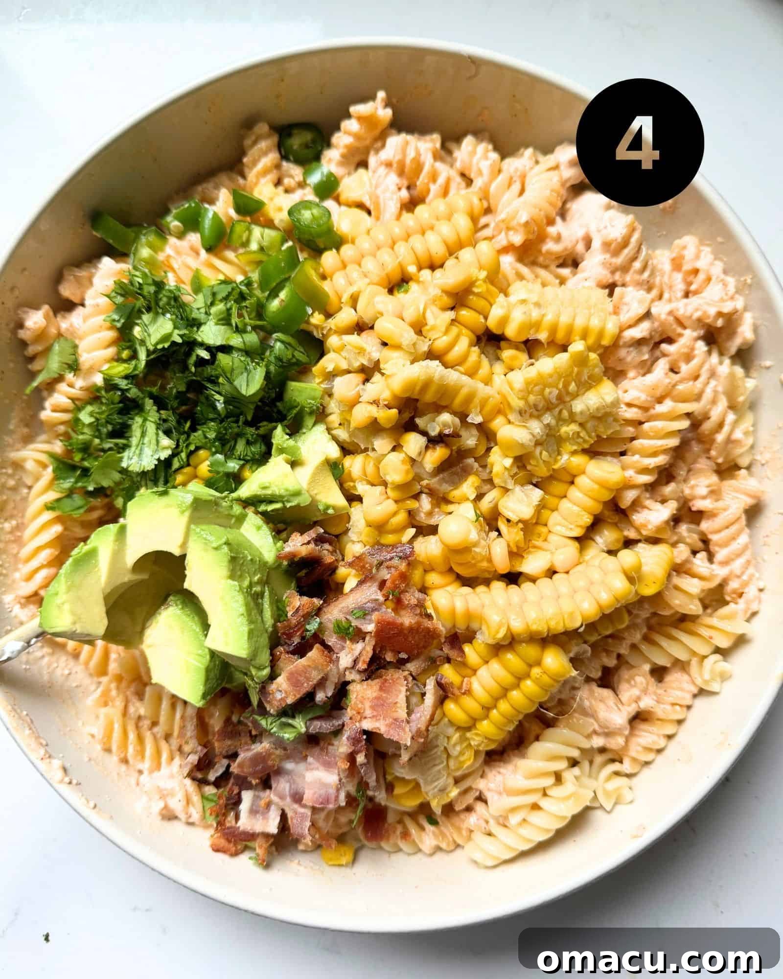 Mexican street corn salad ingredients thoroughly mixed together in a large bowl.