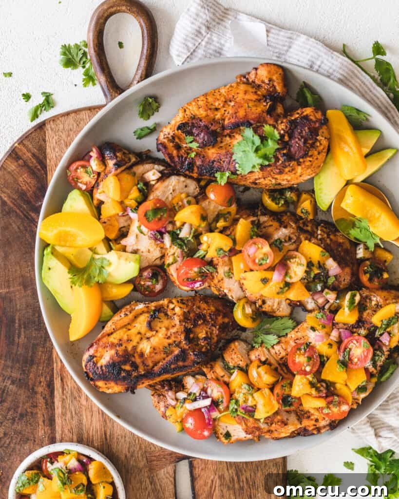 Another view of Honey Garlic Chicken with peach salsa on a plate, highlighting the texture