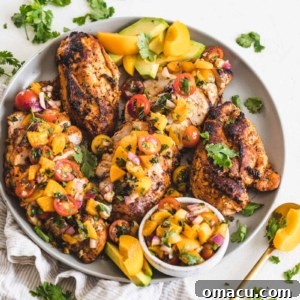 Honey Garlic Chicken topped with peach salsa on a plate