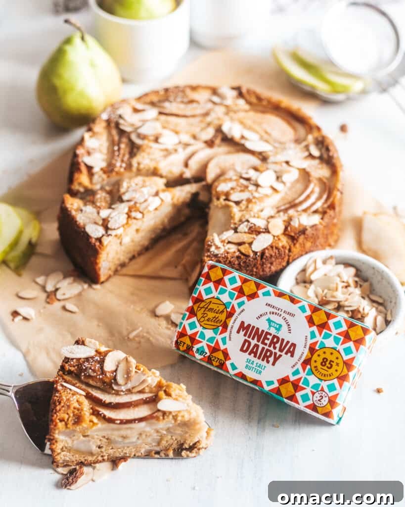 Another view of the Spiced Pear and Almond Cake, showcasing its golden crust and the beautiful arrangement of pear slices on top.