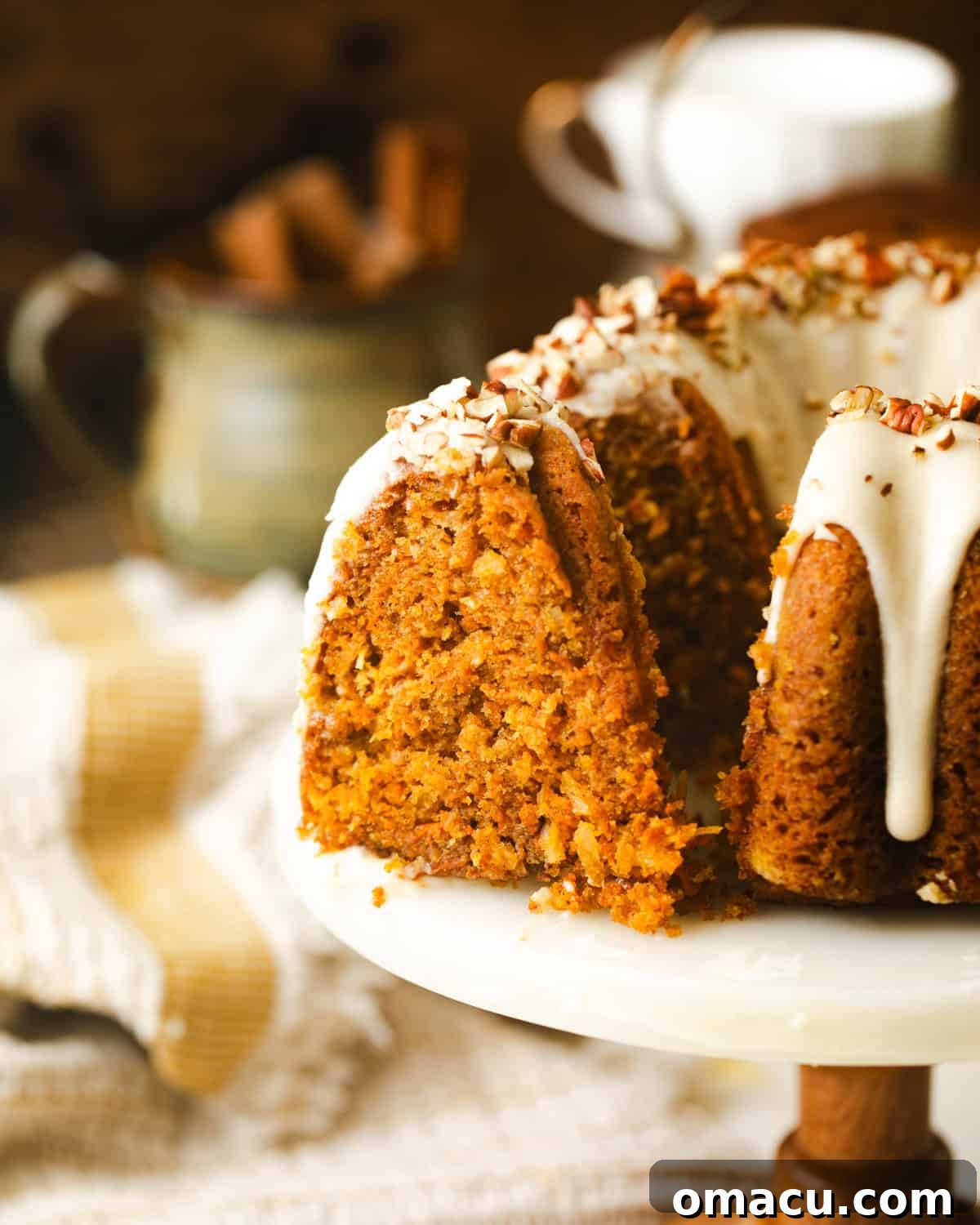 Sliced carrot bundt cake on a cake stand.