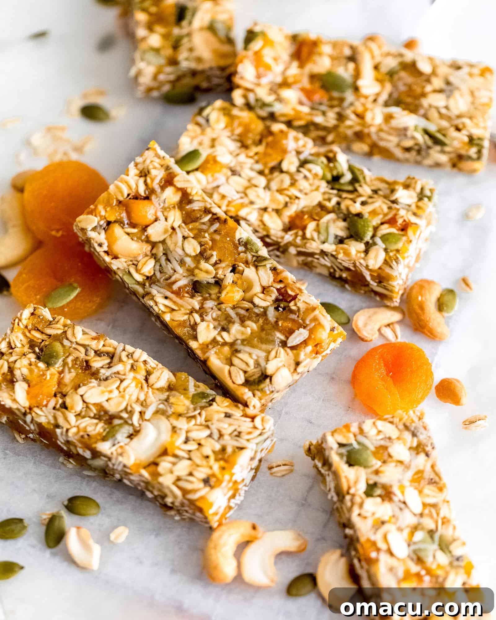 A close-up shot showcasing the dense, wholesome texture of a freshly cut Apricot Coconut Cashew Bar, ready to be enjoyed.