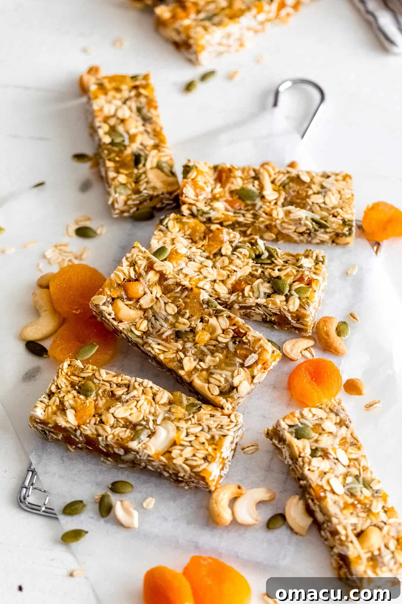 An overhead shot featuring a batch of Apricot Coconut Cashew Bars cut into perfect squares, artfully arranged for presentation.