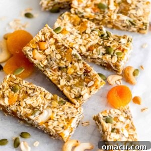 A close-up shot showcasing the dense, wholesome texture of a freshly cut Apricot Coconut Cashew Bar, ready to be enjoyed.